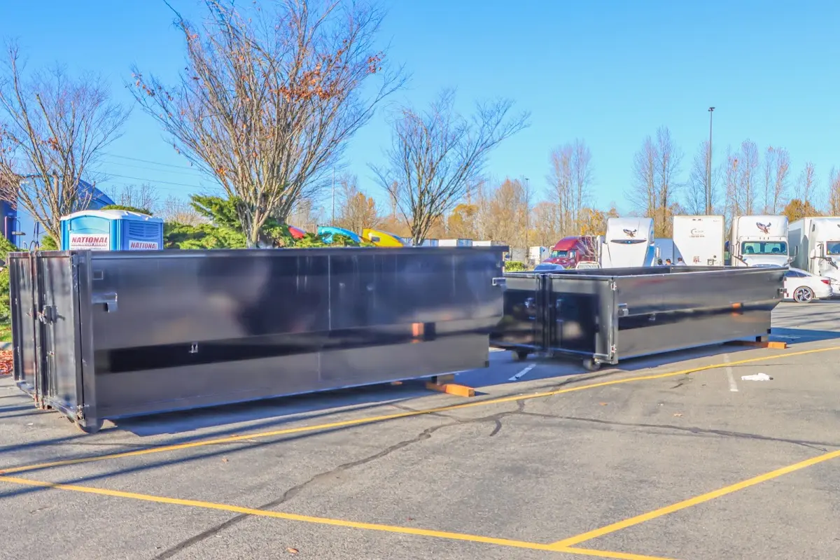 Professional dumpster rental service with roll-off container on residential driveway in Pine Hills
